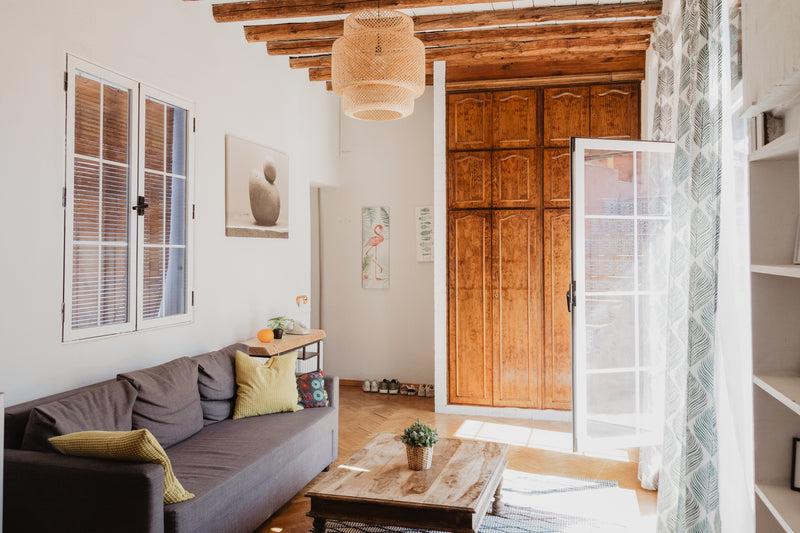 best airbnb aps - sunlight creeps through a bright living room - a living room with a couch and a coffee table