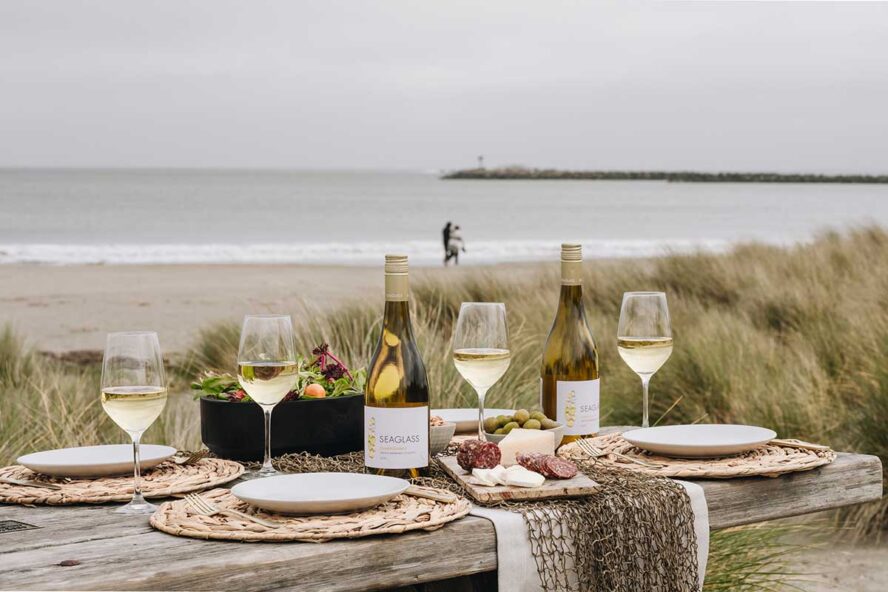 ocean table setting with chilled bubbly from the best wine fridge for vacation rentals